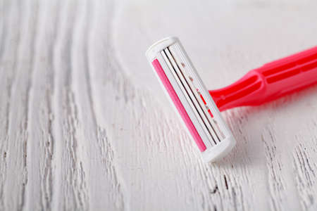 Pink razor on white