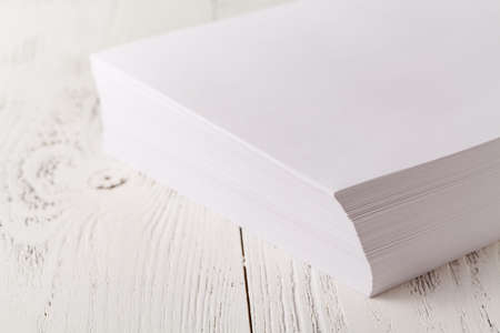 Stacked white paper on white