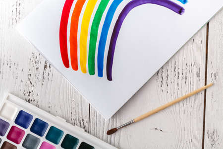 Kid's drawing with colorful rainbowの写真素材