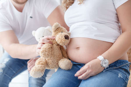 pregnant woman and her handsome husband are play while spending time togetherの写真素材