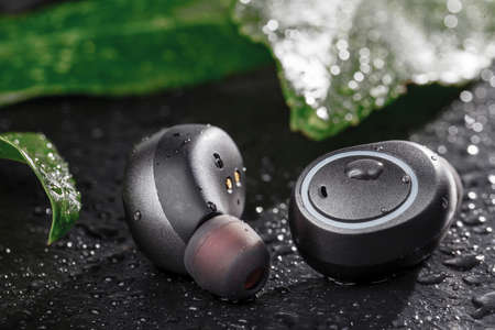 Waterproof headphones, earphones black, beaded with water. Headphones for running in the rainの写真素材