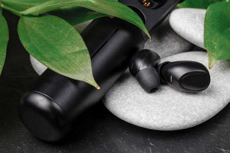 Cordless earphones with power box for long time listening musicの写真素材