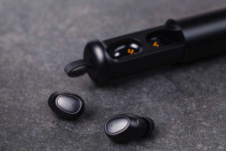 Cordless earphones with power box for long time listening musicの写真素材