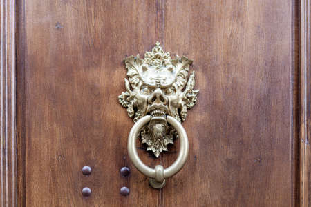 Old wooden entrance door with antique door handleの写真素材
