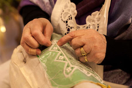 Elderly while embroidering a lace in burano island near Venice in Italyの写真素材