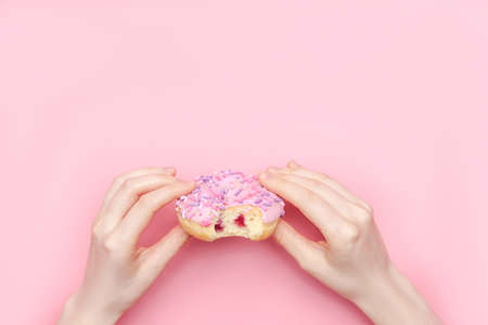 Donuts with icing on pastel pink background. Sweet donutsの写真素材