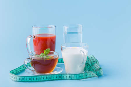 three glasses with water, milk and juice closeupの写真素材