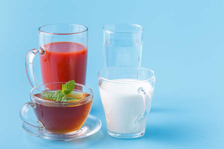 Group Useful Colorful Beverages Drink Milk Tea Juice Water on  Blue Backgroundの写真素材
