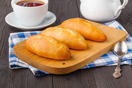 Savory stuffed patties on an wooden table. Country house styleの写真素材