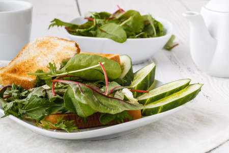 Diet healthy food. Bread with avacado, tomatoes and basilの写真素材