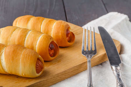 Home made pigs in a blanket. Sausages rolled in croissant dough, bakedの写真素材