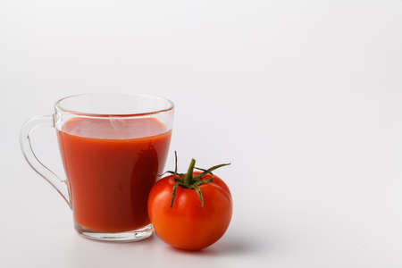 Fresh tomato juice in glass. Vegetable drink from organic natural tomatoの写真素材