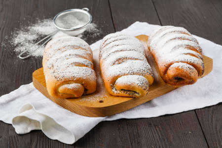 Puff pastry apple pastry turnovers for dessert on a wooden tableの写真素材