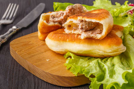 Triangular Russian belyashi with meatの写真素材