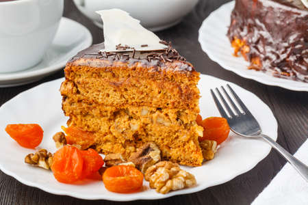 Slice of layered honey cake. Russian cake Medovik with walnutsの写真素材