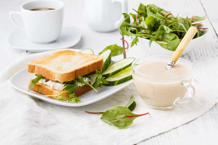 Healthy sandwiches with multi grain bread, cream cheese and greensの写真素材