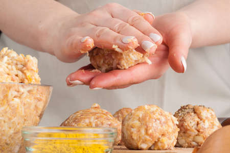 hands prepare meatballs from chicken meatの写真素材