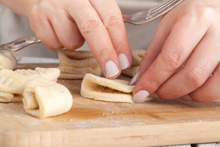 Baking christmas cookies on brown wooden tableの写真素材