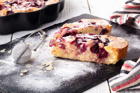 tart with blackberry on dark back sliced pie with berriesの写真素材