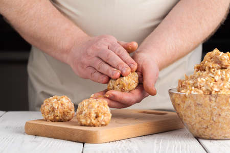 hands prepare meatballs from chicken meatの写真素材