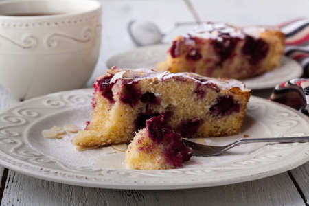 Breakfast concept, Homemade slice of shortbread dough raspberry pie with almond petalsの写真素材