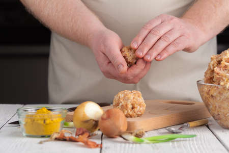 hands prepare meatballs from chicken meatの写真素材