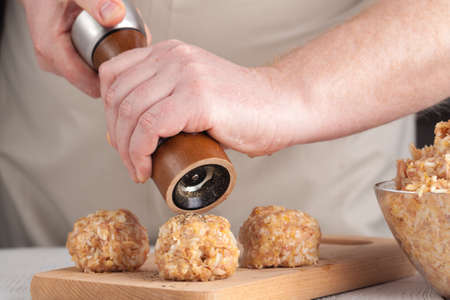 hands prepare meatballs from chicken meatの写真素材