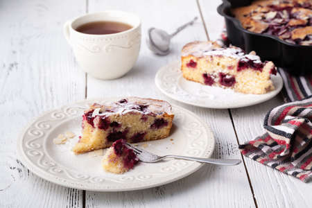 Breakfast concept, Homemade slice of shortbread dough raspberry pie with almond petalsの写真素材