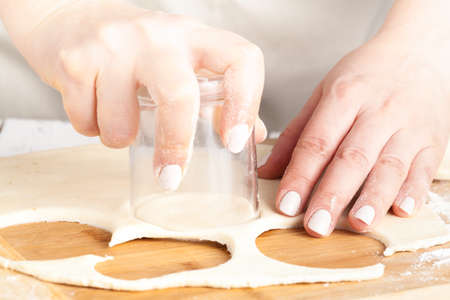 Baking christmas cookies on brown wooden tableの写真素材