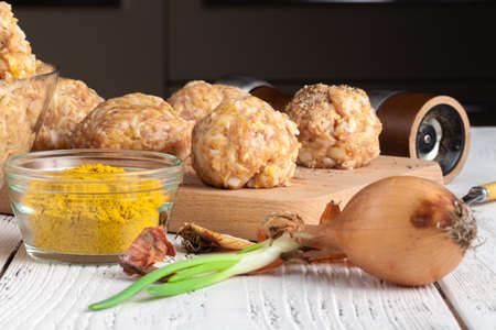 homemade meatballs with cheese, garlic and black pepper on the wooden chopping boardの写真素材