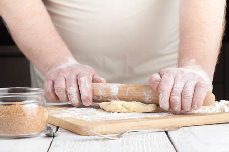 Baking christmas cookies on brown wooden tableの写真素材