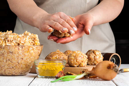 homemade meatballs with cheese, garlic and black pepper on the wooden chopping boardの写真素材