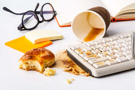 coffee spilling on keyboard ib work place officeの写真素材