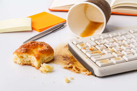 Spilled coffee on computer keyboardの写真素材