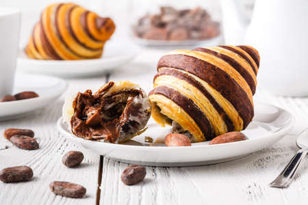 Croissants with chocolate filling cup and fresh morning coffeeの写真素材