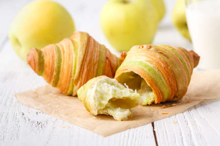 traditional breakfast with fresh croissants and white wooden backgroundの写真素材