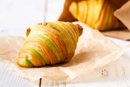 traditional breakfast with fresh croissants and white wooden backgroundの写真素材