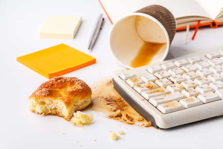coffee spilling on keyboard ib work place officeの写真素材