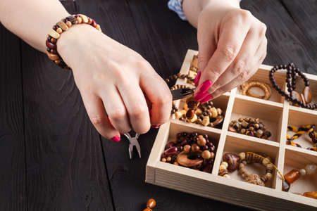 Free time evening making beads. Woman leisure home work, masterclass conceptの写真素材