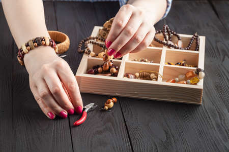 beautiful women at the table making jewelryの写真素材