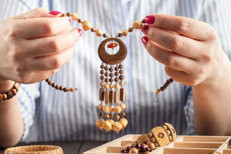 Woman making jewelry at homeの写真素材