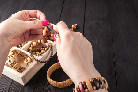 beautiful women at the table making jewelry