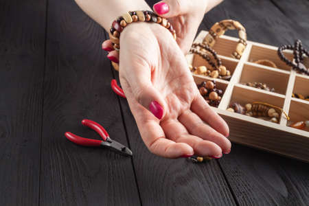 Homemade jewelry. Woman making home craft art bijouterie