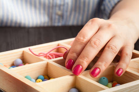 beautiful women at the table making jewelryの写真素材