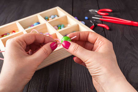 Homemade jewelry. Woman making home craft art bijouterie