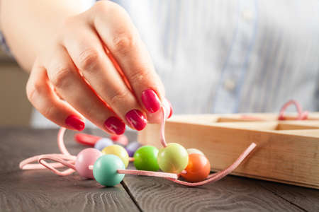 Jewelry making and beading process.Colored beads.Beaded jewelryの写真素材
