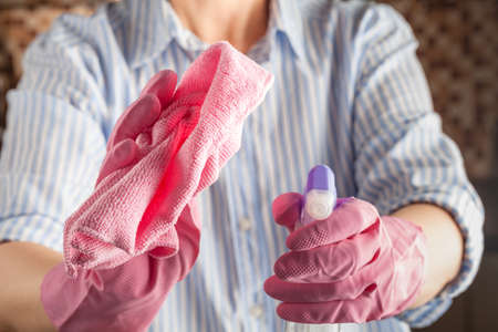 Washing the windows in the house with a rag and a spray for cleaning glasses. Cleaning the houseの写真素材