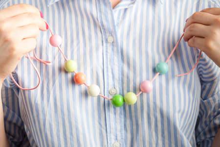 Working process. Handcraft concept. Creative woman making beautiful beads of colorful ballsの写真素材