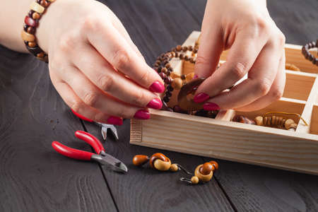 Woman making jewelry at homeの写真素材