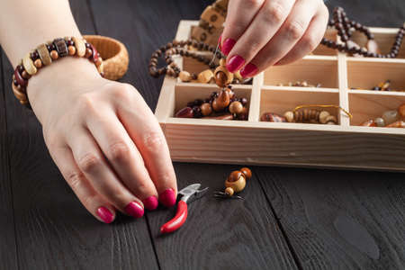 Handmade beading preparation on wooden table, DIY conceptの写真素材